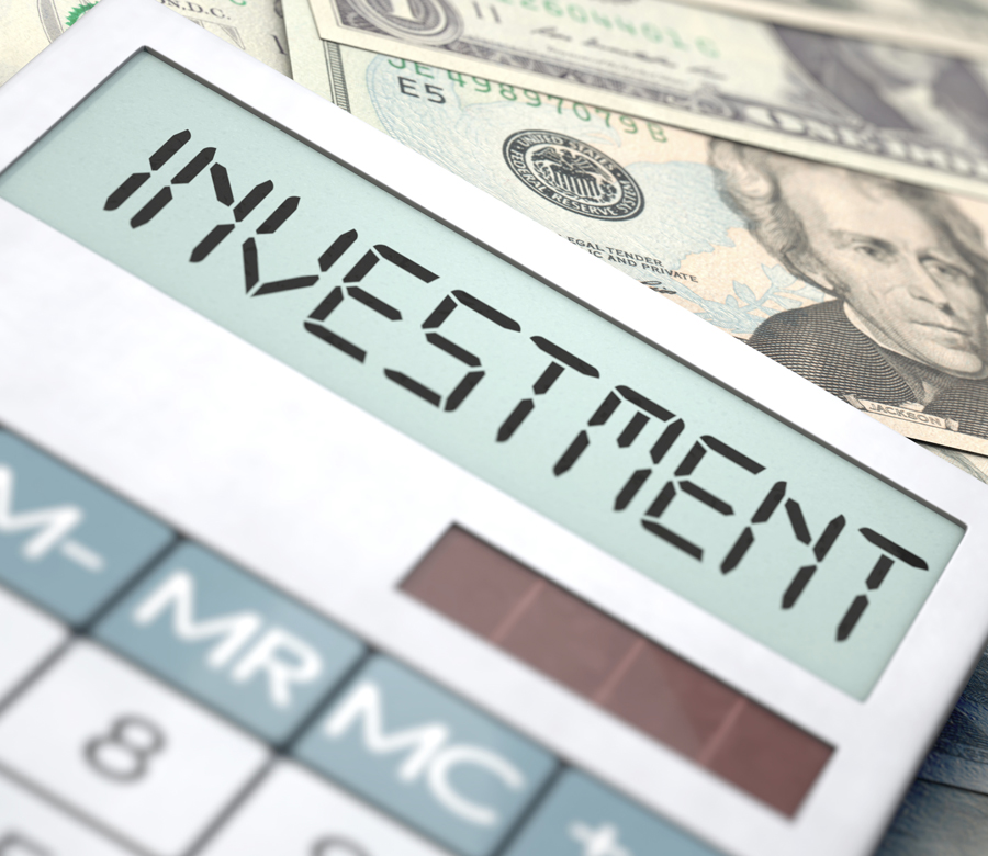 Investment calculator laying on money.